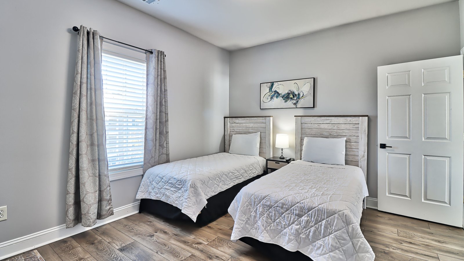 JM Villas third bedroom with two beds